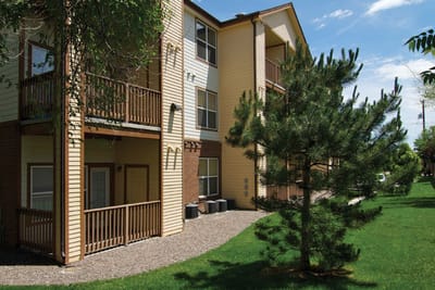 Exterior view of Pinecrest Apartments with surrounding greenery