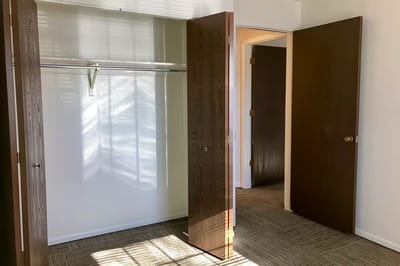 Empty resident room with open closet and natural light