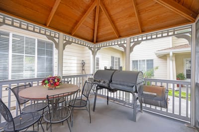 Outdoor barbecue area with a table and chairs