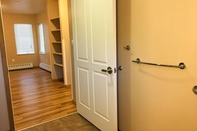 Interior view of a resident room with a door open
