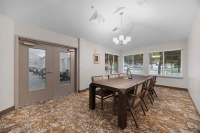 Bright common area with a large table and chairs