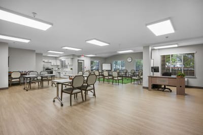 Bright common area with seating and a kitchenette