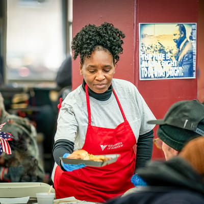 Staff serving food to residents during an event