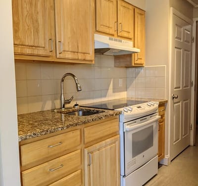 Modern kitchen area with wooden cabinets