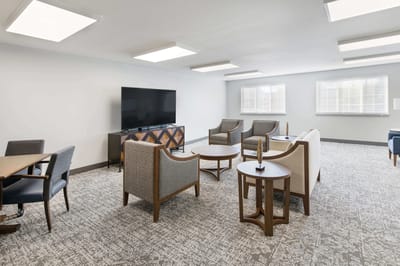 Spacious common area with seating and television