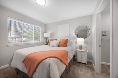 Well-decorated resident room with cozy bedding and natural light
