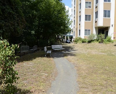 Outdoor seated area with benches near the facility