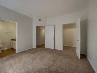 Empty resident room with neutral walls and carpet