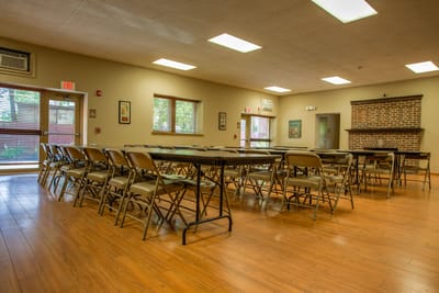 Common area with tables and chairs set up for activities