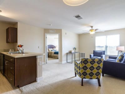 Interior view of a resident suite with living area and kitchen