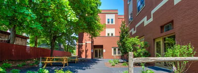 Exterior view of Nathan Hale Apartments with outdoor seating