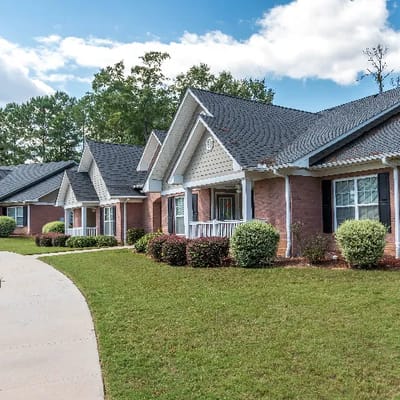Exterior view of a senior living building with landscaped gardens