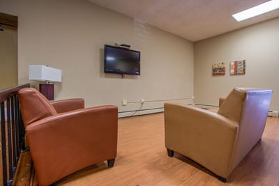 Interior of a common area with chairs and a TV