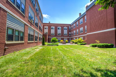 Outdoor courtyard with grass and seating area