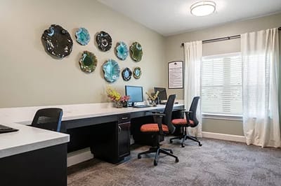 Brightly lit activity room with office spaces