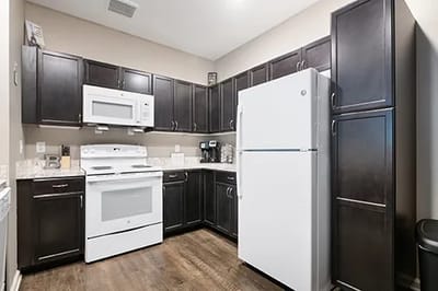 Modern kitchen with dark wooden cabinets and appliances
