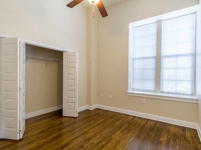 Bright, empty resident room with hardwood floor