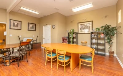 Common area with a large round table and seating
