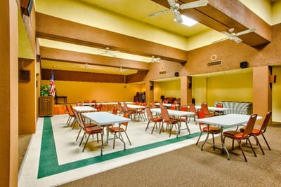 Interior view of a large common area with tables and chairs