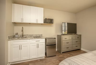 Private resident room with kitchenette and TV