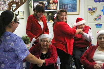 Residents and staff celebrating with festive attire.