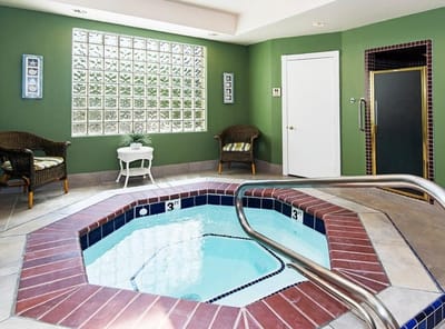 Indoor spa area with hot tub and seating