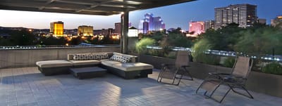 Outdoor seating area with city skyline in the background
