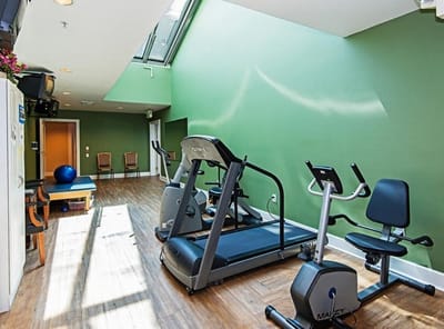 Bright fitness area with exercise equipment and natural light