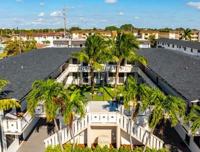 Aerial view of Plaza Gardenia Apartments with palm trees