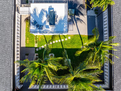 Aerial view of a courtyard with seating and palm trees