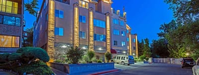 Exterior view of the facility at night with landscaping