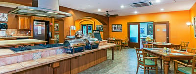Interior dining area with orange walls and tables