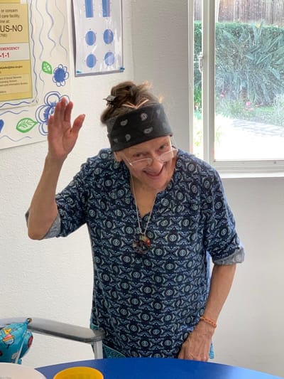 A woman greeting with a smile in a facility interior