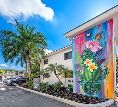 Exterior view of the facility with vibrant mural and landscaping