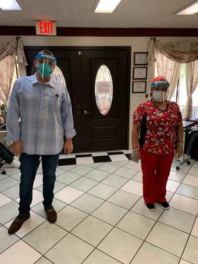 Staff members in protective gear inside the facility