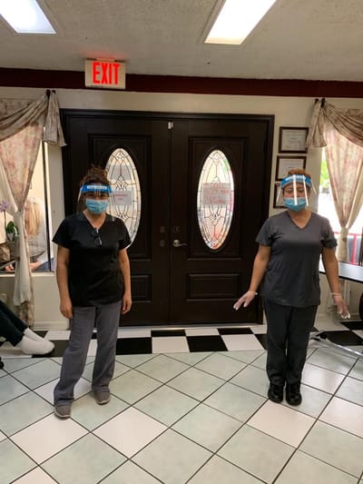 Staff members wearing face shields in the entrance area