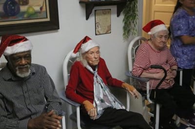 Residents celebrating with festive hats and decorations