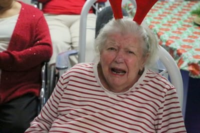 Resident with festive antlers in a holiday celebration