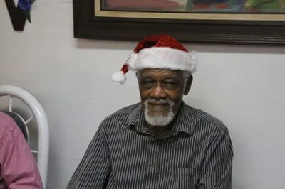 Resident celebrating with a festive Santa hat