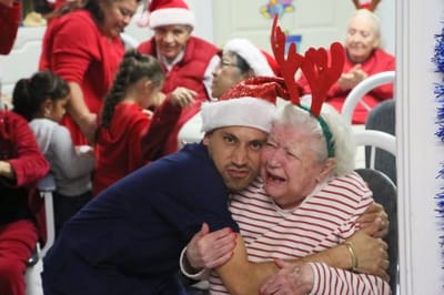 Residents and staff celebrating with festive hats