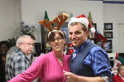 Residents and staff celebrate with festive attire during an event