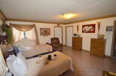 Interior view of a private resident room with beds and decor