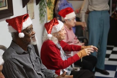 Residents celebrating with Santa hats in a festive interior