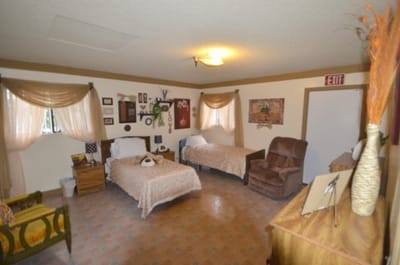 A cozy resident room with two beds and decor