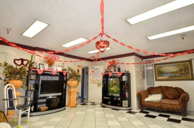 Common area decorated with heart streamers and floral arrangements
