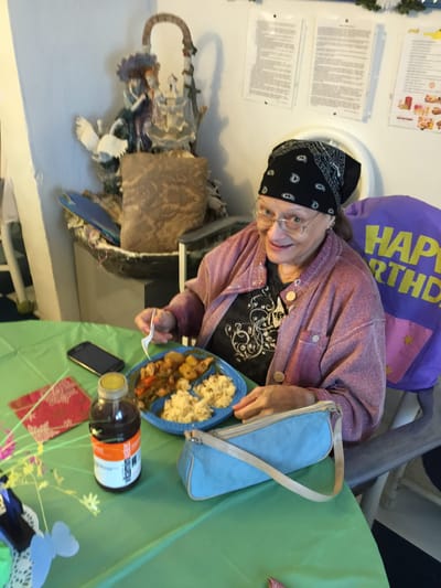 Resident enjoying a meal in a cozy dining setting