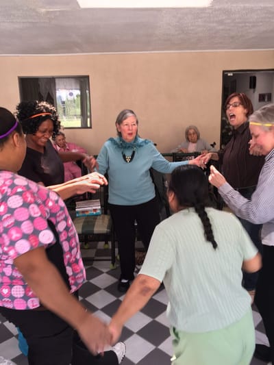 Residents and staff engaging in a joyful group activity