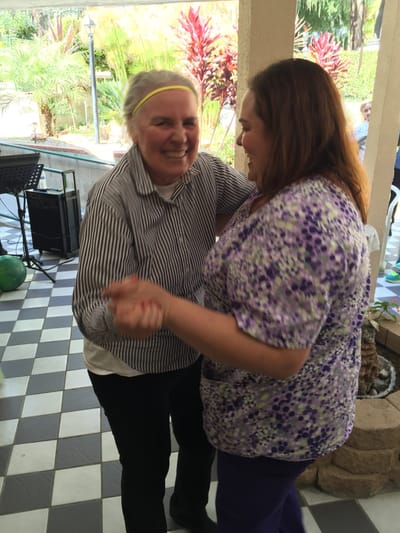 Residents dancing in a vibrant common area