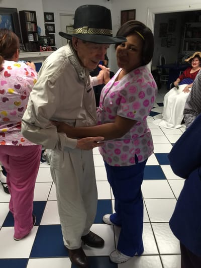 Staff dancing with resident in a common area