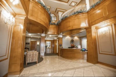 Elegant lobby with wooden accents and seating area.